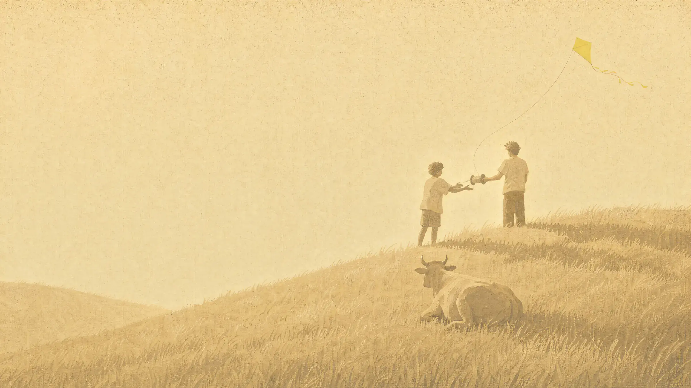 On a hill of dry grass one person hands a kite spool to another while a citrine kite flies high above them and a cow lies in the grass below, watching it.